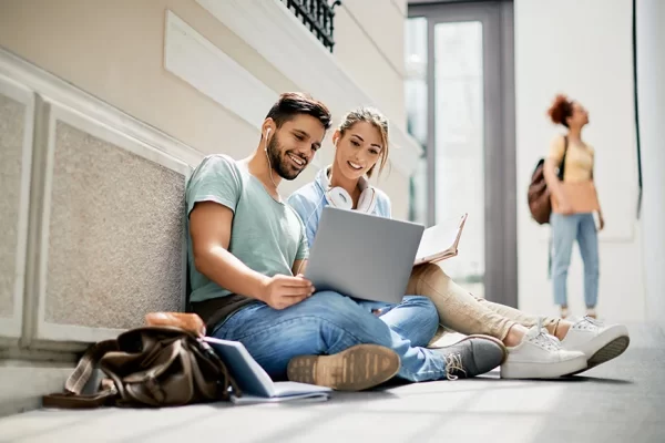 happy-university-friends-using-laptop-while-studyi-2022-11-09-03-50-42-utc happy-university-friends-using-laptop-while-studyi-2022-11-09-03-50-42-utc